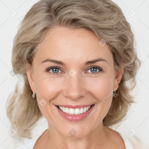 Joyful white adult female with medium  brown hair and blue eyes