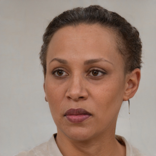 Neutral latino adult female with short  brown hair and brown eyes
