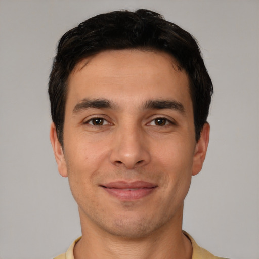 Joyful white young-adult male with short  brown hair and brown eyes