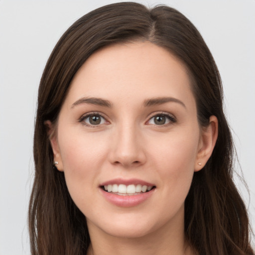 Joyful white young-adult female with long  brown hair and grey eyes