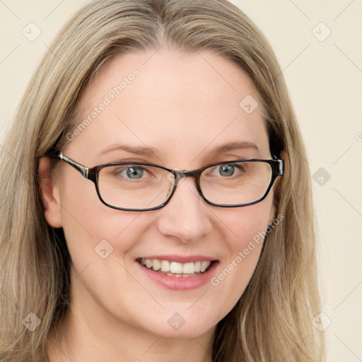 Joyful white young-adult female with long  brown hair and blue eyes