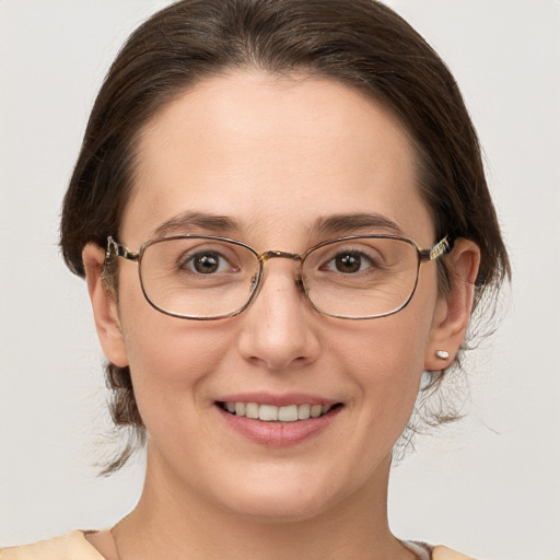 Joyful white adult female with medium  brown hair and grey eyes