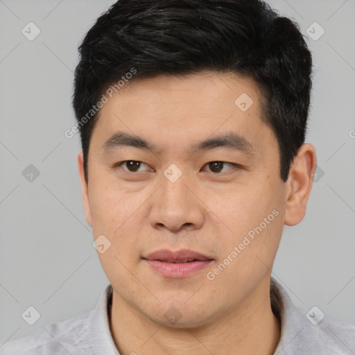 Joyful asian young-adult male with short  black hair and brown eyes