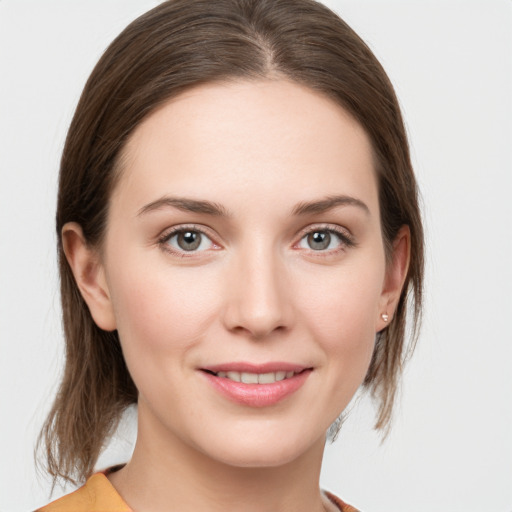 Joyful white young-adult female with medium  brown hair and grey eyes