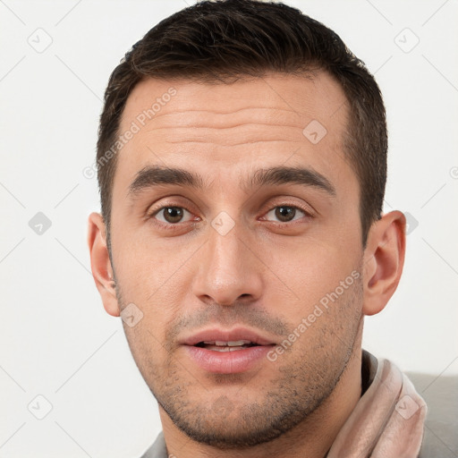 Joyful white young-adult male with short  brown hair and brown eyes