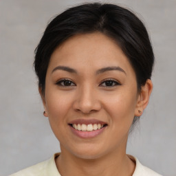 Joyful asian young-adult female with medium  brown hair and brown eyes