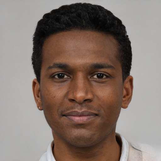 Joyful black young-adult male with short  black hair and brown eyes