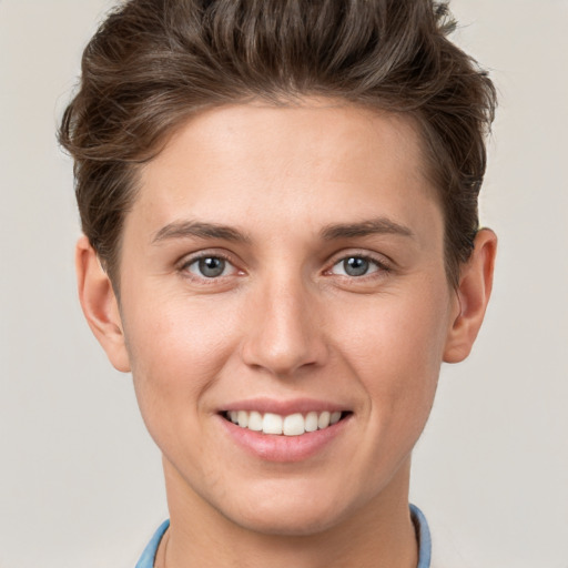 Joyful white young-adult female with short  brown hair and grey eyes