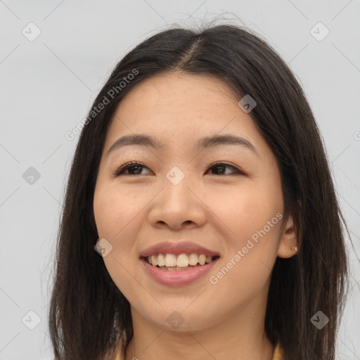 Joyful asian young-adult female with long  brown hair and brown eyes