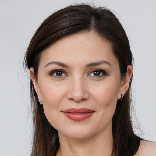 Joyful white young-adult female with long  brown hair and brown eyes