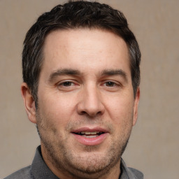 Joyful white adult male with short  brown hair and brown eyes