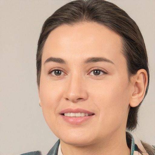 Joyful white young-adult female with medium  brown hair and brown eyes