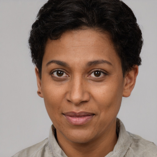 Joyful latino adult female with short  brown hair and brown eyes