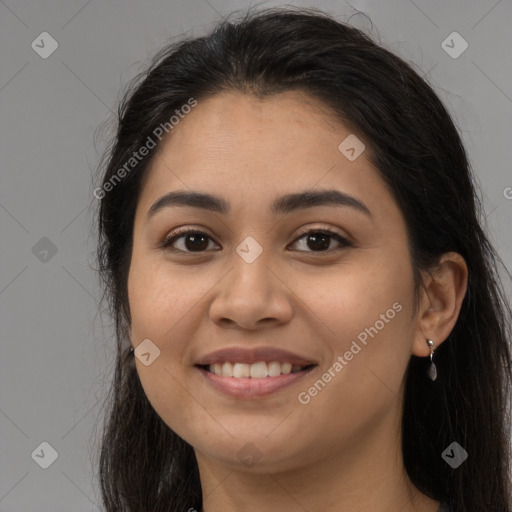 Joyful latino young-adult female with long  brown hair and brown eyes