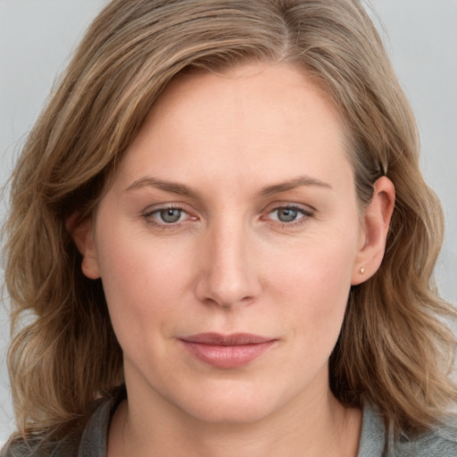 Joyful white young-adult female with medium  brown hair and blue eyes