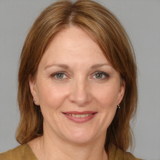 Joyful white adult female with medium  brown hair and brown eyes