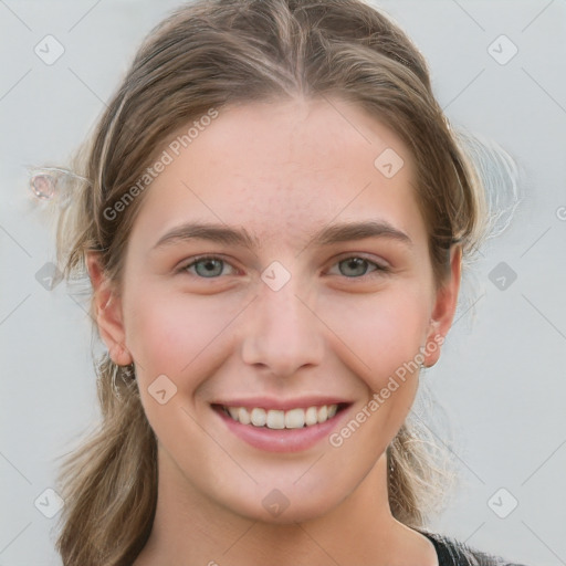 Joyful white young-adult female with medium  brown hair and grey eyes