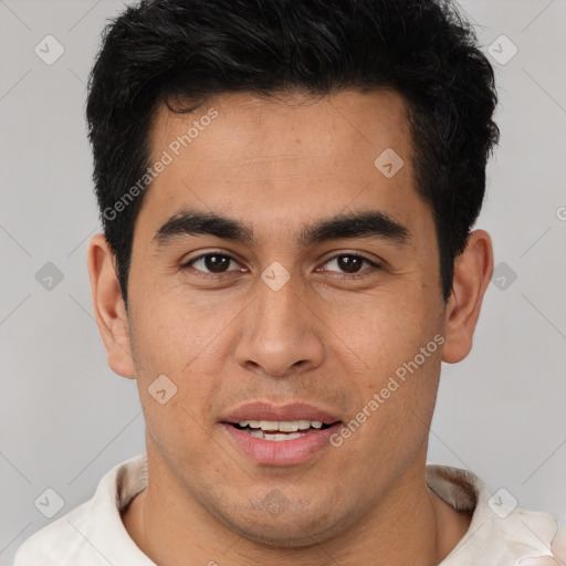 Joyful latino young-adult male with short  brown hair and brown eyes