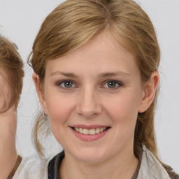 Joyful white young-adult female with medium  brown hair and blue eyes