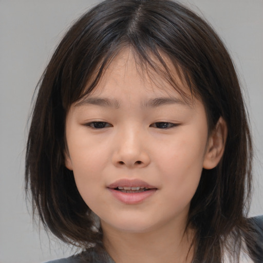 Joyful asian child female with medium  brown hair and brown eyes