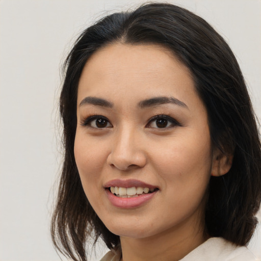 Joyful asian young-adult female with medium  black hair and brown eyes