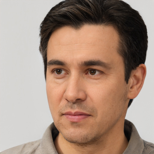 Joyful white adult male with short  brown hair and brown eyes