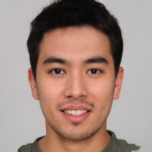 Joyful asian young-adult male with short  black hair and brown eyes