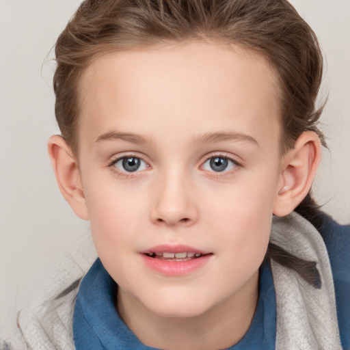 Joyful white child female with short  brown hair and blue eyes