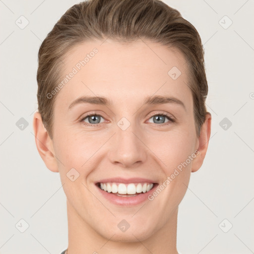 Joyful white young-adult female with short  brown hair and grey eyes