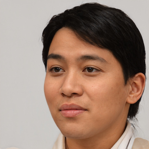 Joyful asian young-adult male with short  black hair and brown eyes