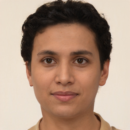 Joyful latino young-adult male with short  brown hair and brown eyes