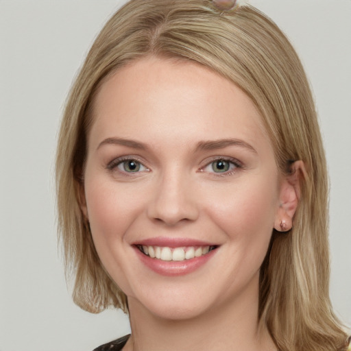 Joyful white young-adult female with medium  brown hair and blue eyes