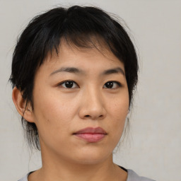 Neutral asian young-adult female with medium  brown hair and brown eyes