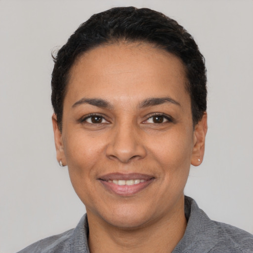 Joyful latino adult female with short  black hair and brown eyes