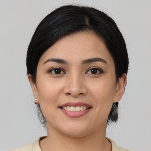Joyful latino young-adult female with medium  black hair and brown eyes