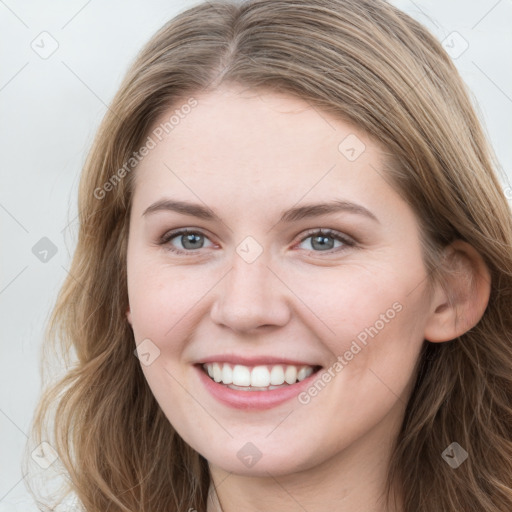 Joyful white young-adult female with long  brown hair and grey eyes