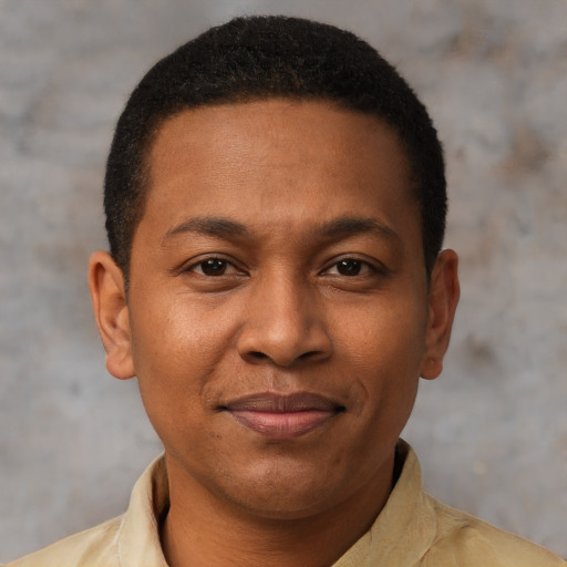 Joyful latino young-adult male with short  brown hair and brown eyes
