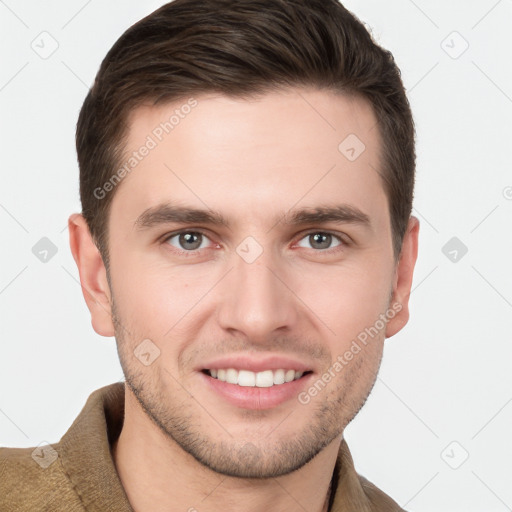 Joyful white young-adult male with short  brown hair and grey eyes