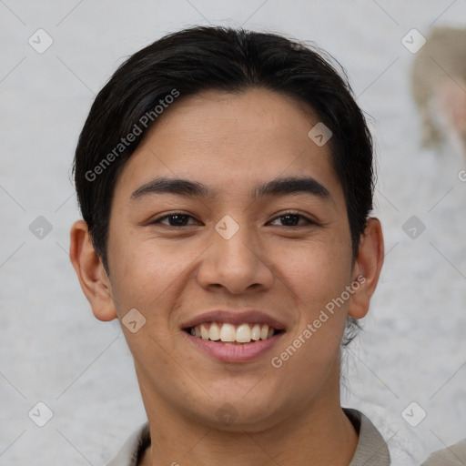 Joyful asian young-adult male with short  brown hair and brown eyes