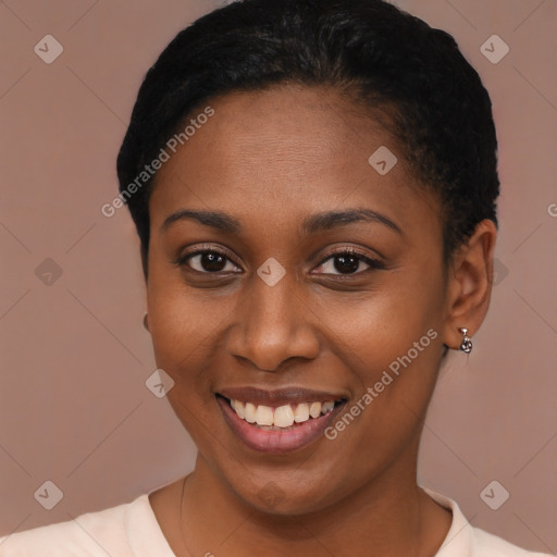 Joyful black young-adult female with short  brown hair and brown eyes