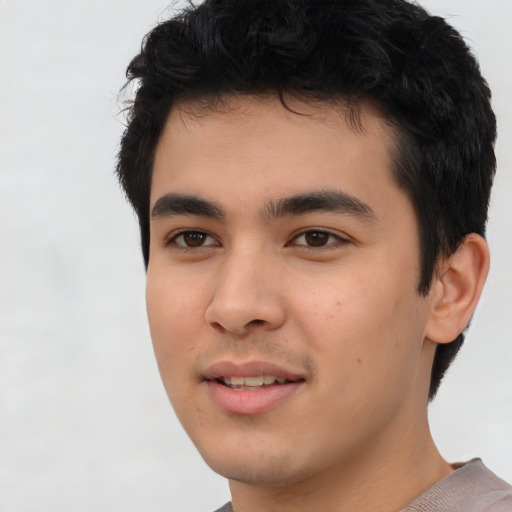 Joyful asian young-adult male with short  black hair and brown eyes