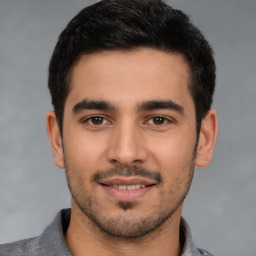 Joyful white young-adult male with short  black hair and brown eyes