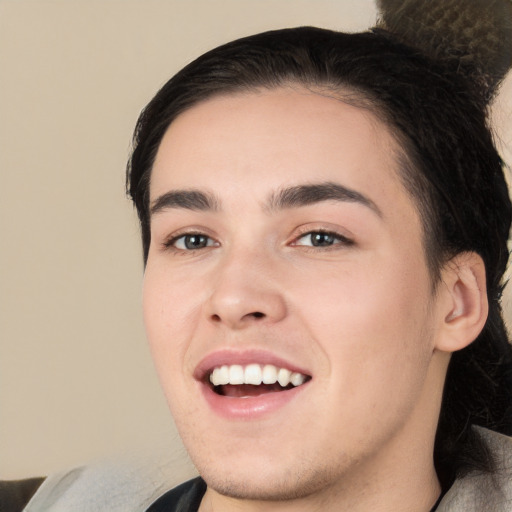 Joyful white young-adult male with medium  black hair and brown eyes