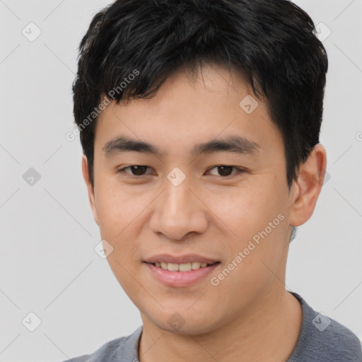 Joyful asian young-adult male with short  brown hair and brown eyes