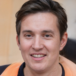 Joyful white adult male with short  brown hair and brown eyes
