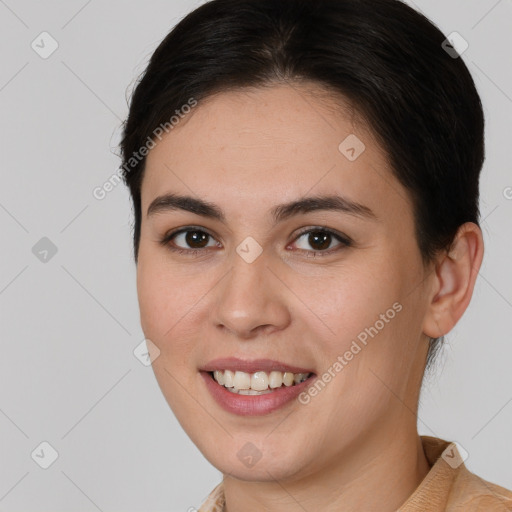 Joyful white young-adult female with short  brown hair and brown eyes