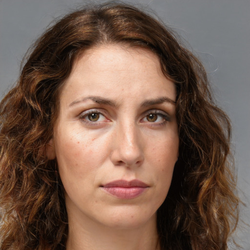 Joyful white young-adult female with long  brown hair and green eyes