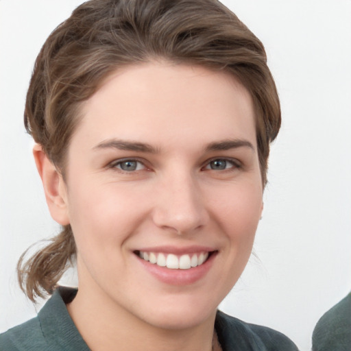 Joyful white young-adult female with medium  brown hair and grey eyes