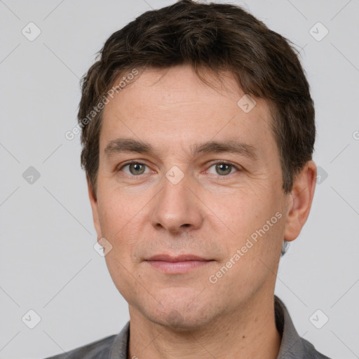 Joyful white adult male with short  brown hair and brown eyes