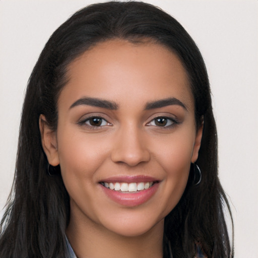 Joyful latino young-adult female with long  black hair and brown eyes